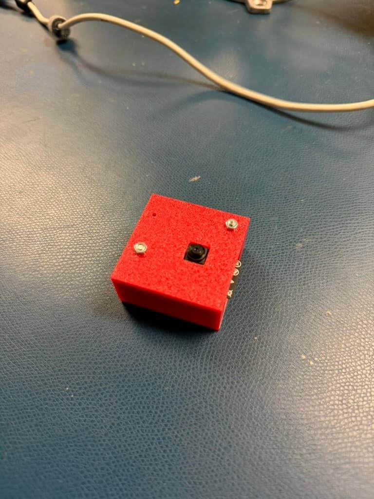 Completed embedded webcam camera module mounted inside a red 3D-printed enclosure