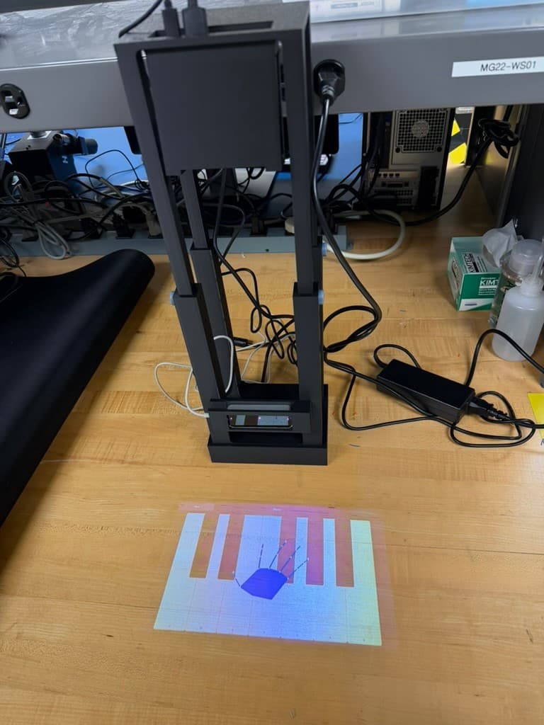 Portable Piano system projecting its DJ sample-pad interface onto a table