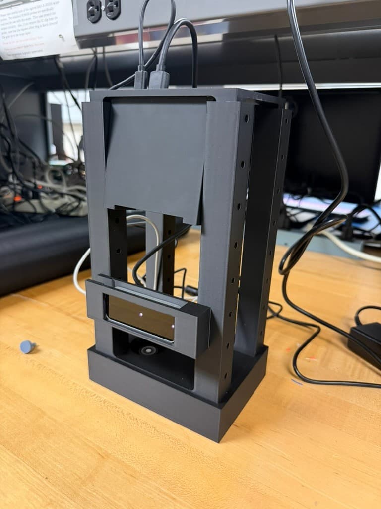 Front view of the assembled black 3D-printed Portable Piano enclosure with projector and Leap Motion sensor