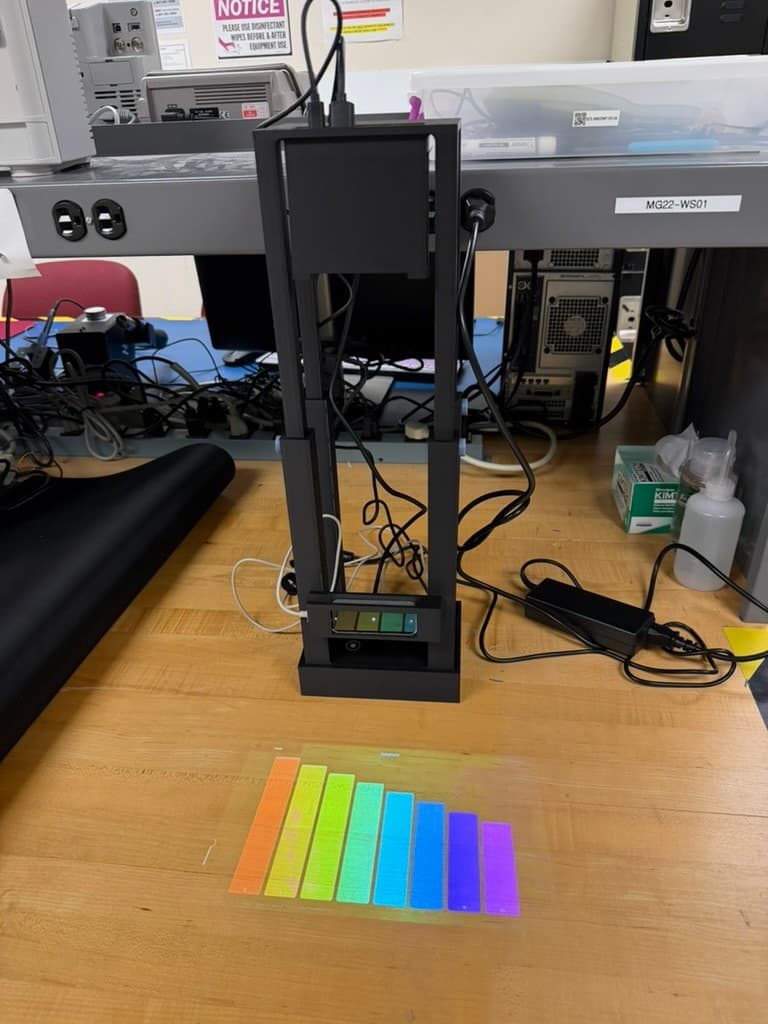 Completed Portable Piano system projecting a colorful xylophone interface onto a table from its custom black enclosure